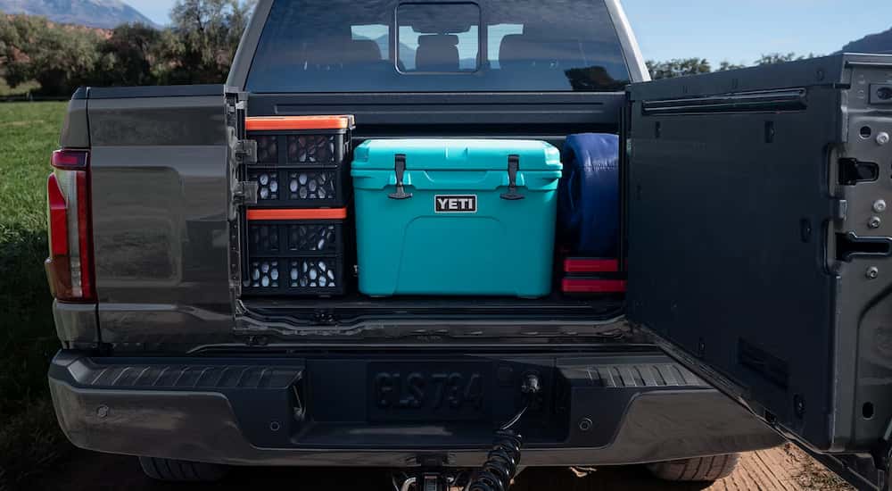 Open tailgate on a grey 2025 Ford F-150 STX.