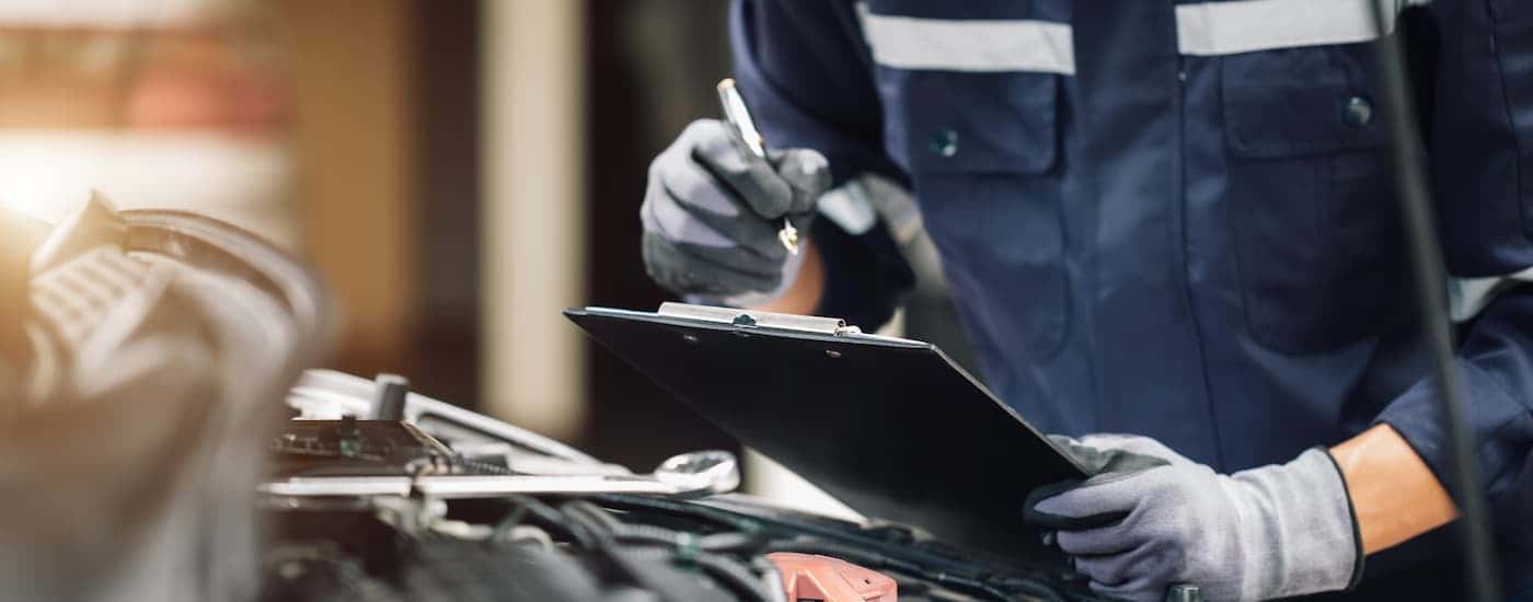 A mechanic holding a clipboard after running transmission diagnostics