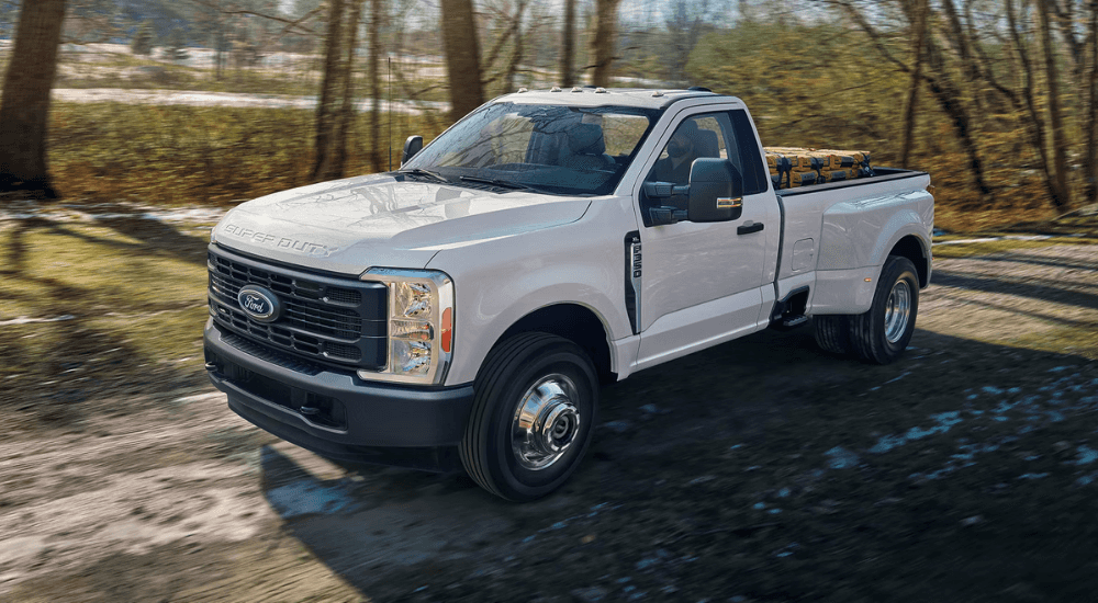 White 2026 Ford Super Duty driving on a dirt road