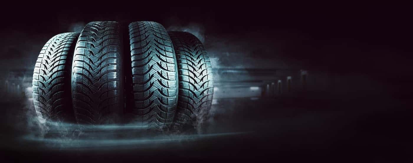 Several tires in a dark room.