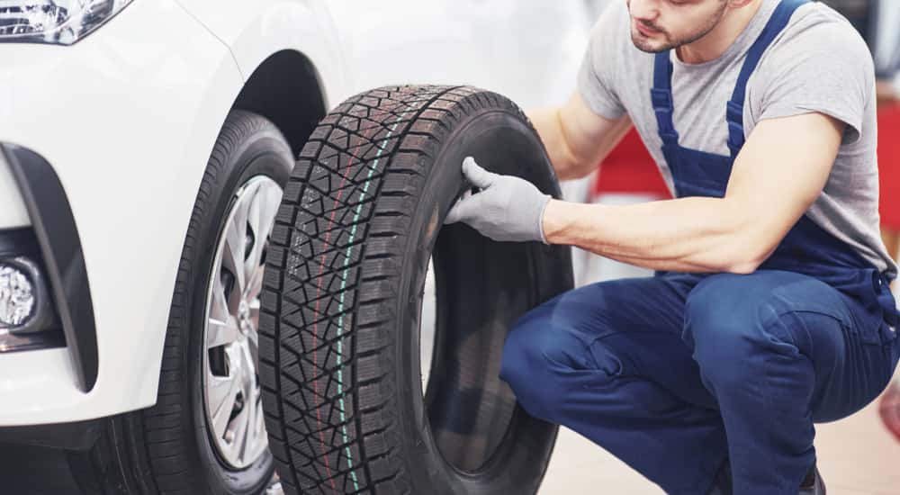 A person getting ready to put on a new tire