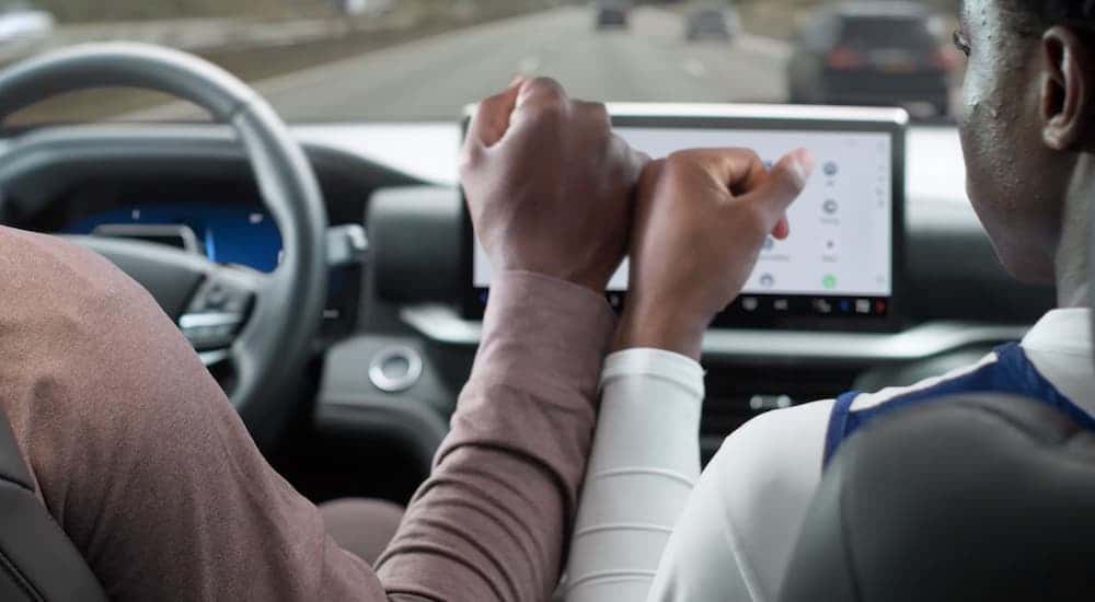 A father and son driving in a 2026 Ford Explorer