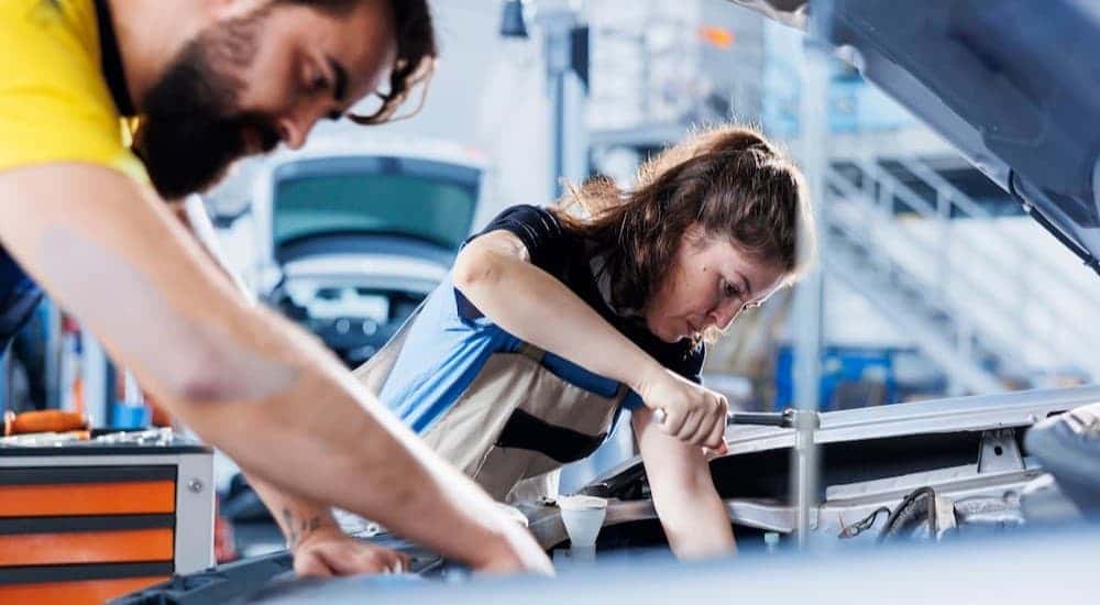 Two technician working on a car.