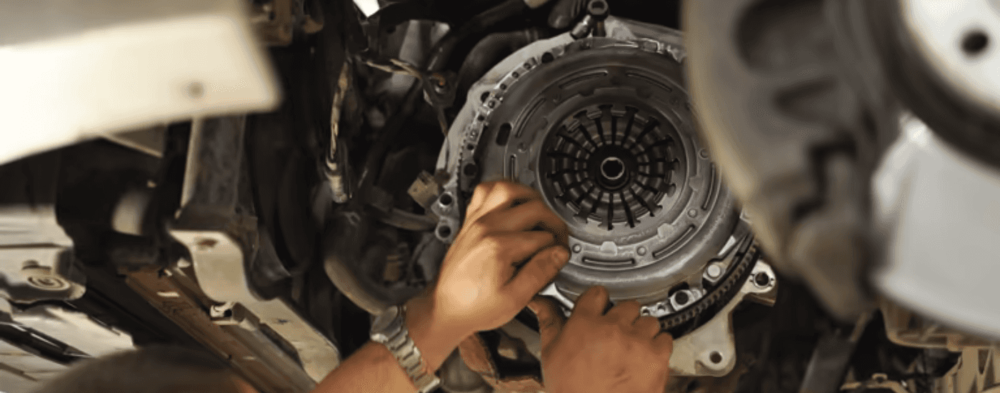 A mechanic performing a transmission repair near Grayson