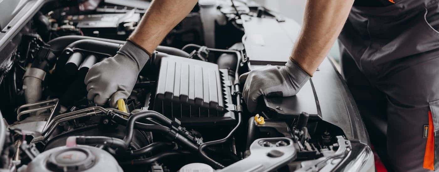 A technician performing an oil change near Monroe.