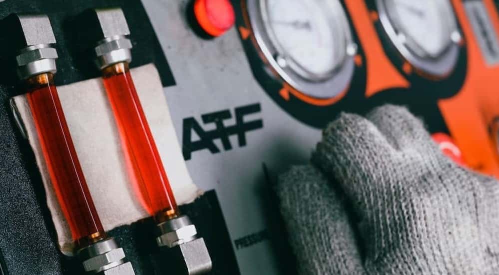 A technician using a transmission fluid flush machine for a transmission repair near Grayson.