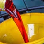 Transmission fluid being poured into a funnel.