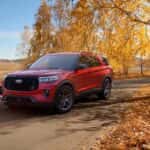A red 2026 Ford Explorer ST parked off-road on a path