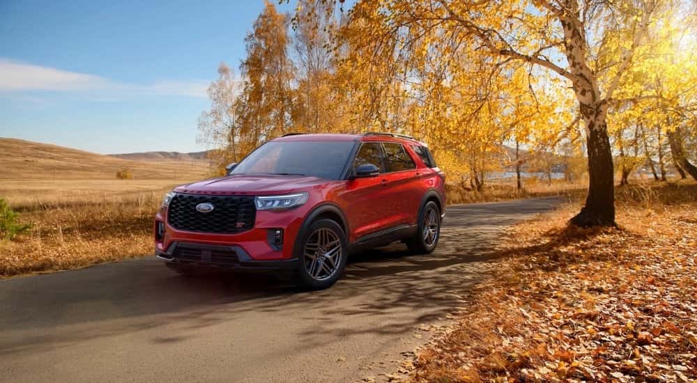 A red 2026 Ford Explorer ST parked off-road on a path