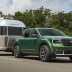 A green 2026 Ford Maverick towing an Airstream camper