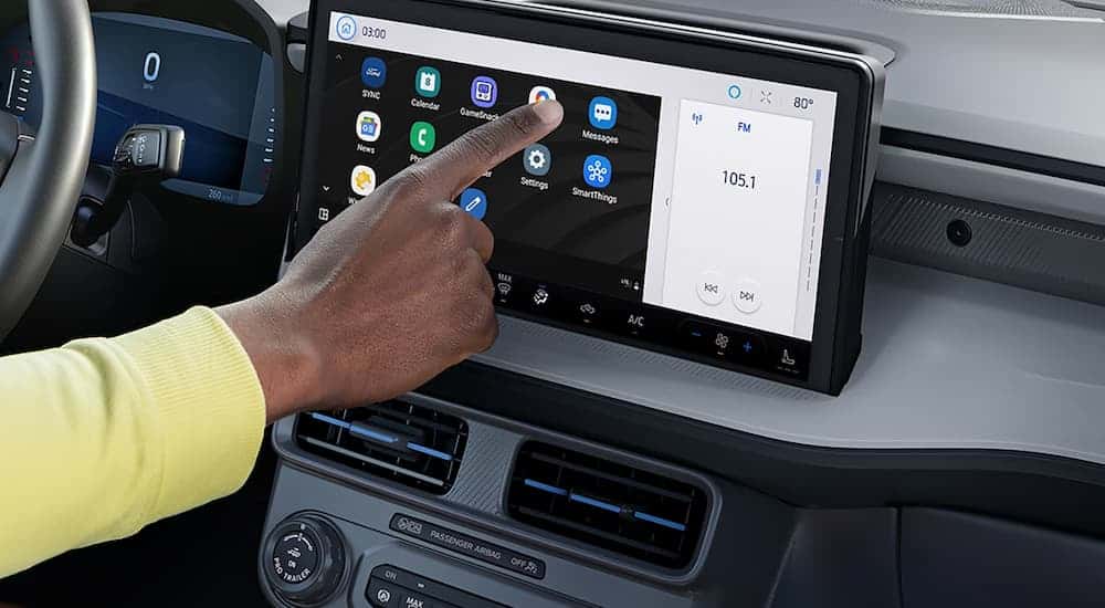 A man using the touch screen infotainment display in a 2026 Ford Maverick
