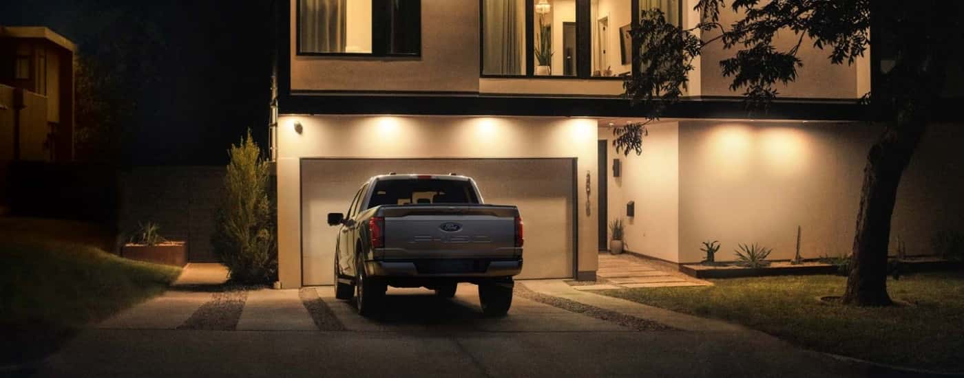 Rear of a silver 2025 Ford F-150 XL parked on a driveway.