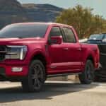 A red 2026 Ford F-150 towing a boat.
