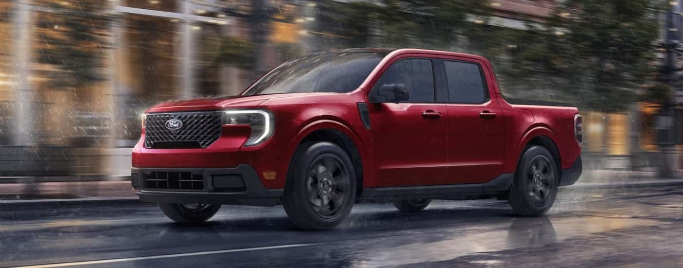 A red 2026 Ford Maverick driving in the rain