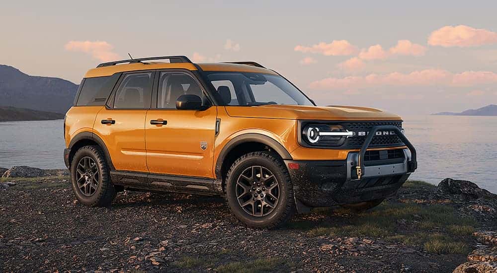 A yellow 2026 Ford Bronco Sport Black Diamond package parked near water