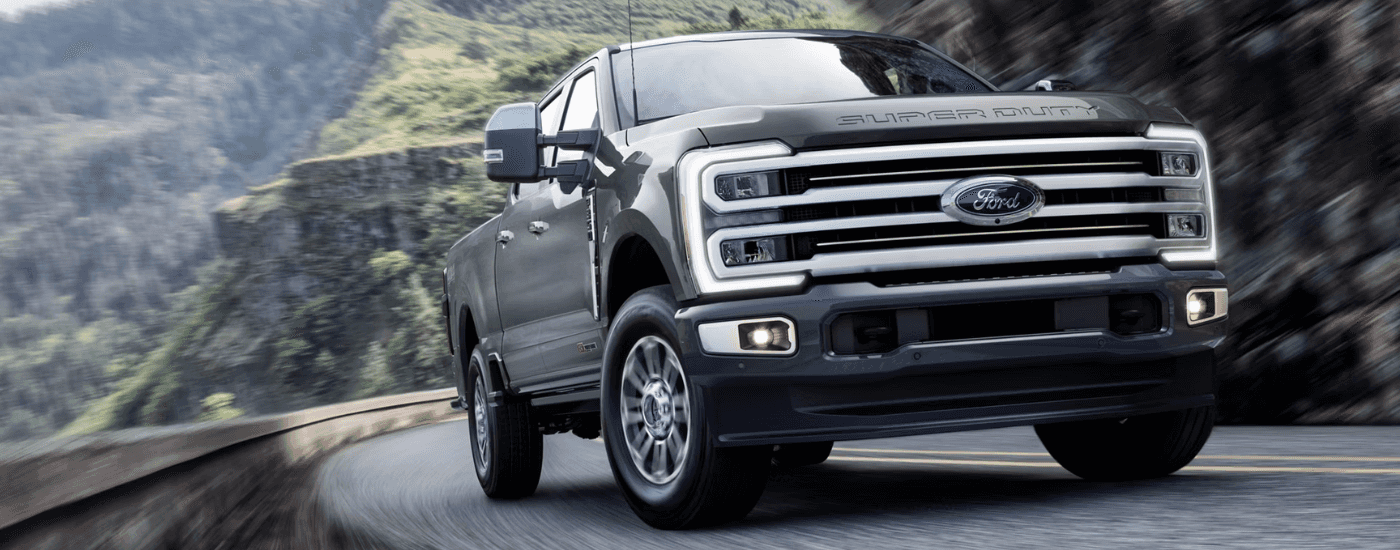 Grey 2026 Ford F-250 Super Duty driving up a hill