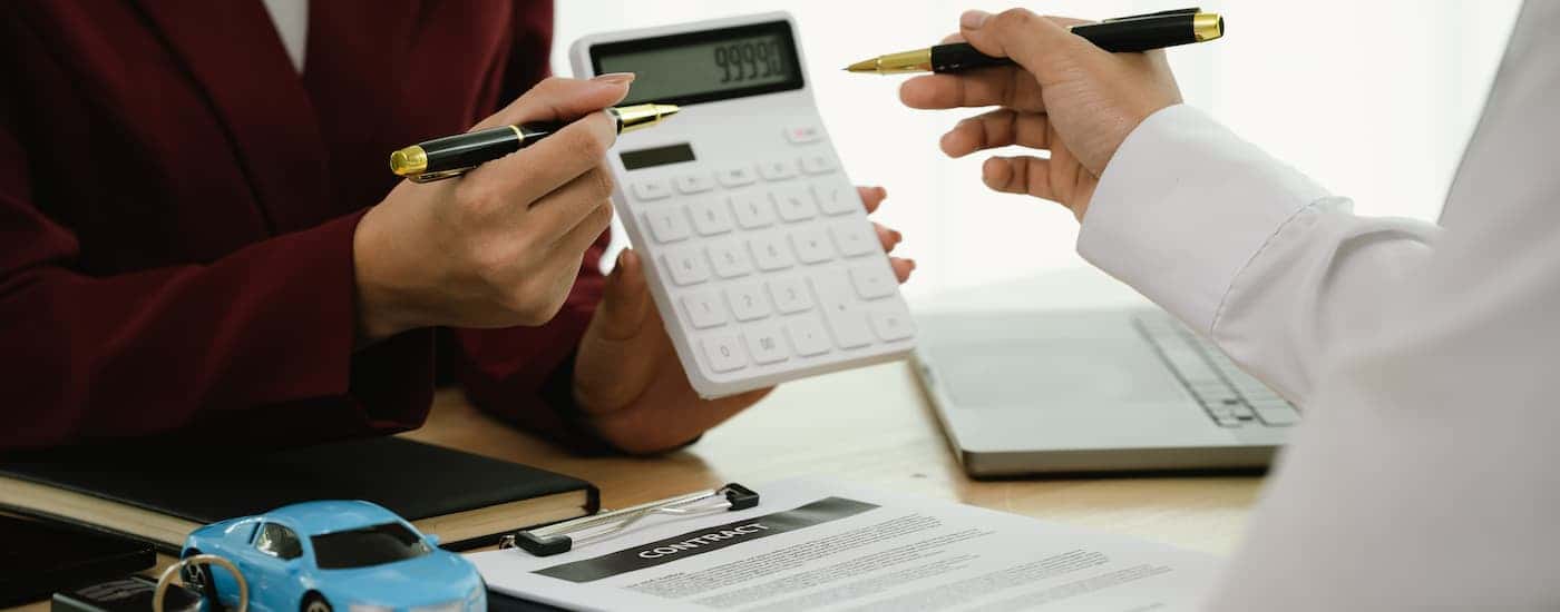 Two people doing car leasing paperwork