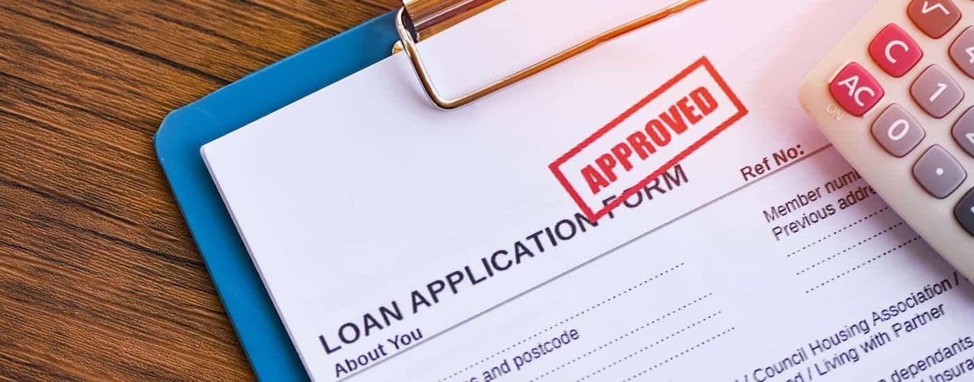 Close-up of an approved loan on a clipboard.