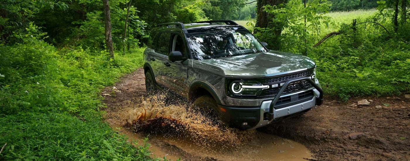 A gray 2026 Ford Bronco Sport off-roading in mud