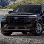 A black 2026 Ford Explorer Active is parked on a rocky beach.