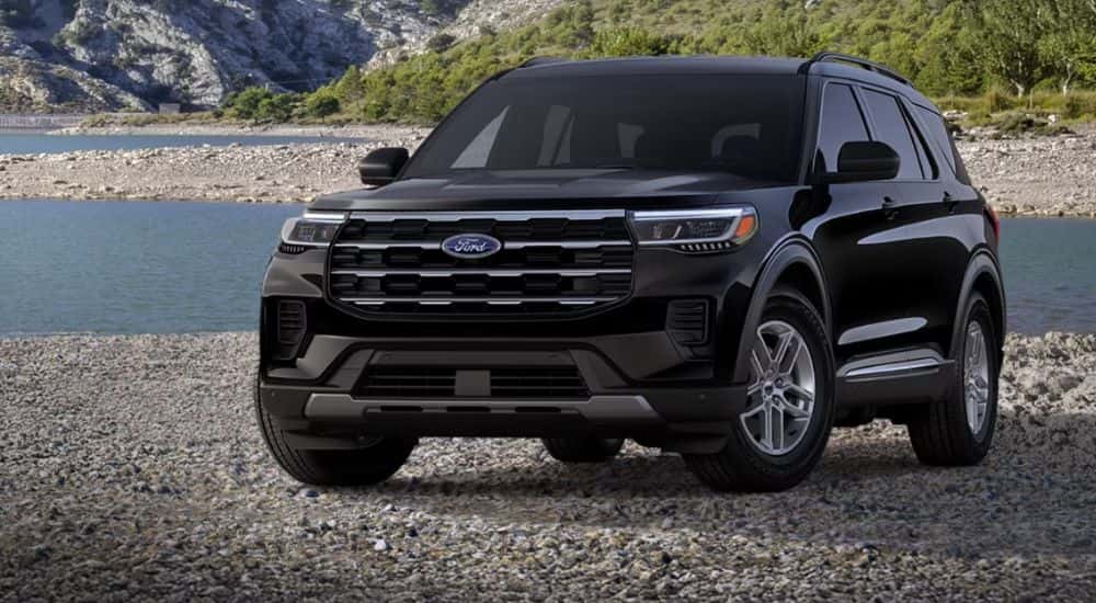 A black 2026 Ford Explorer Active is parked on a rocky beach.