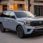 A light blue 2026 Ford Expedition® Platinum® SUV parked in a driveway.