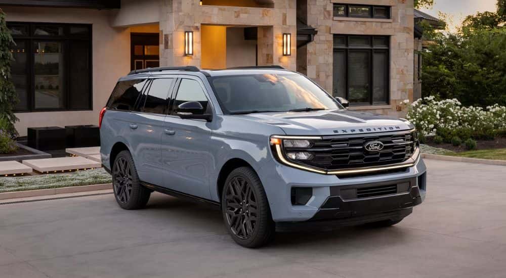 A light blue 2026 Ford Expedition® Platinum® SUV parked in a driveway.