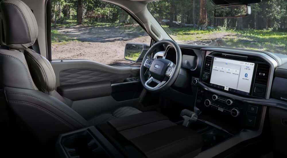 Interior view of a 2026 Ford F-150 Platinum parked in woods.