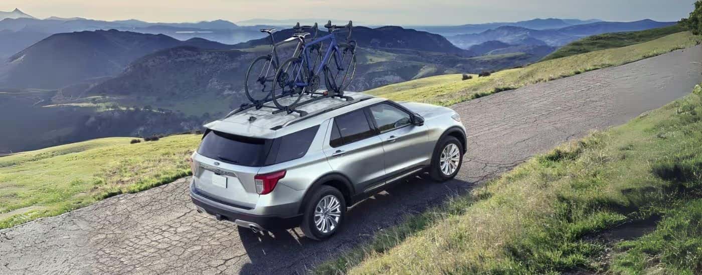 A silver 2022 Ford Explorer driving on a trail.