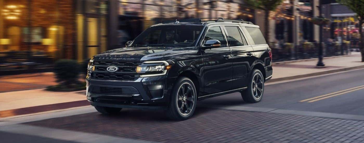 A black 2023 Ford Expedition Stealth Edition driving over a crosswalk.