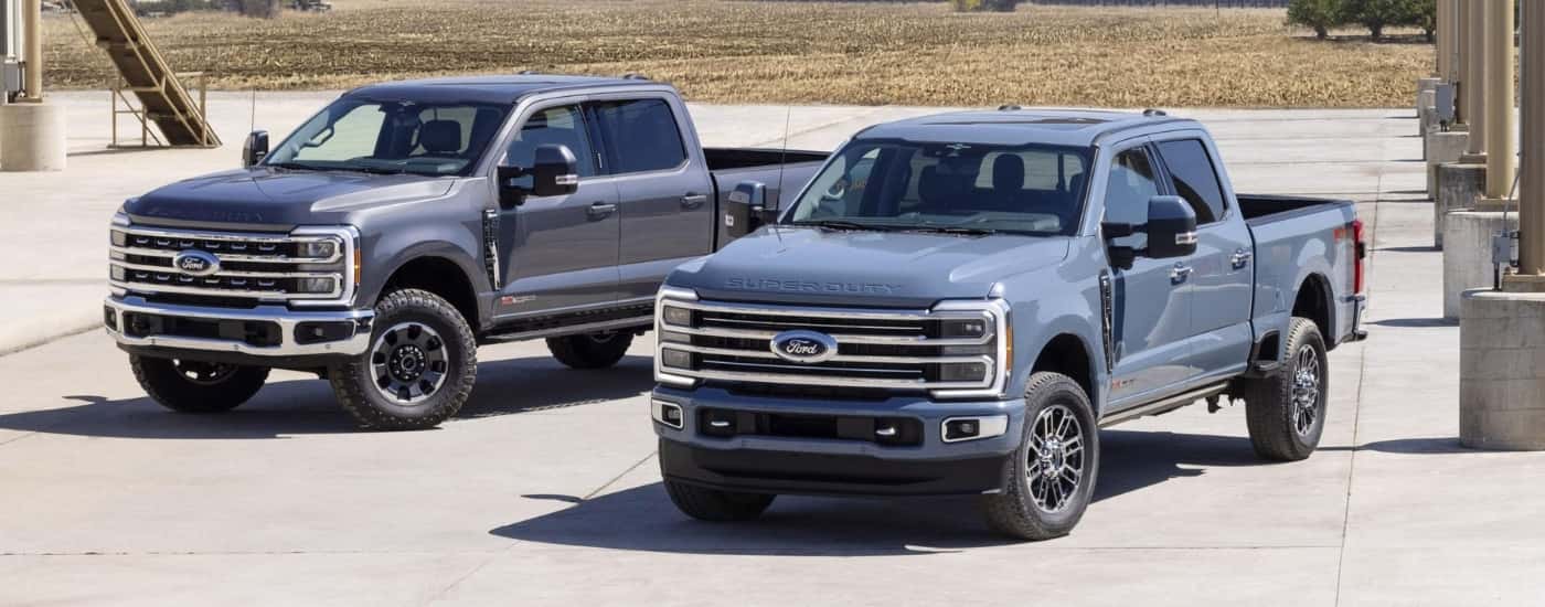 A gray and a blue 2023 Ford F-250 Tremor & F-350 parked side-by-side.