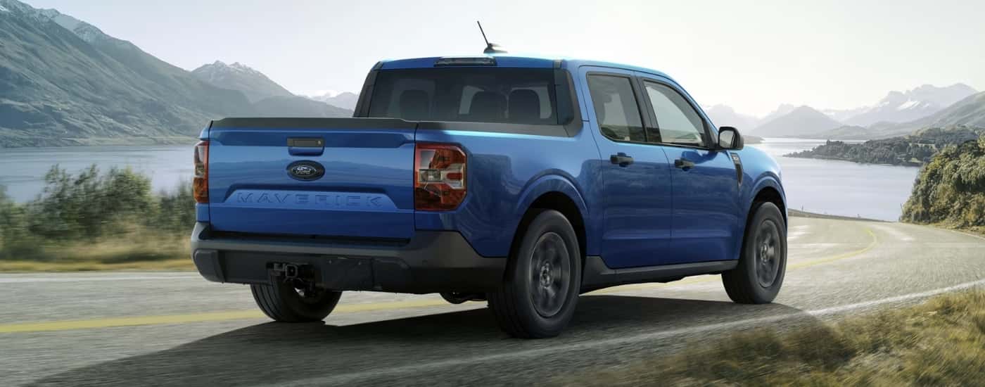 Blue 2026 Ford Maverick XLT driving along a body of water