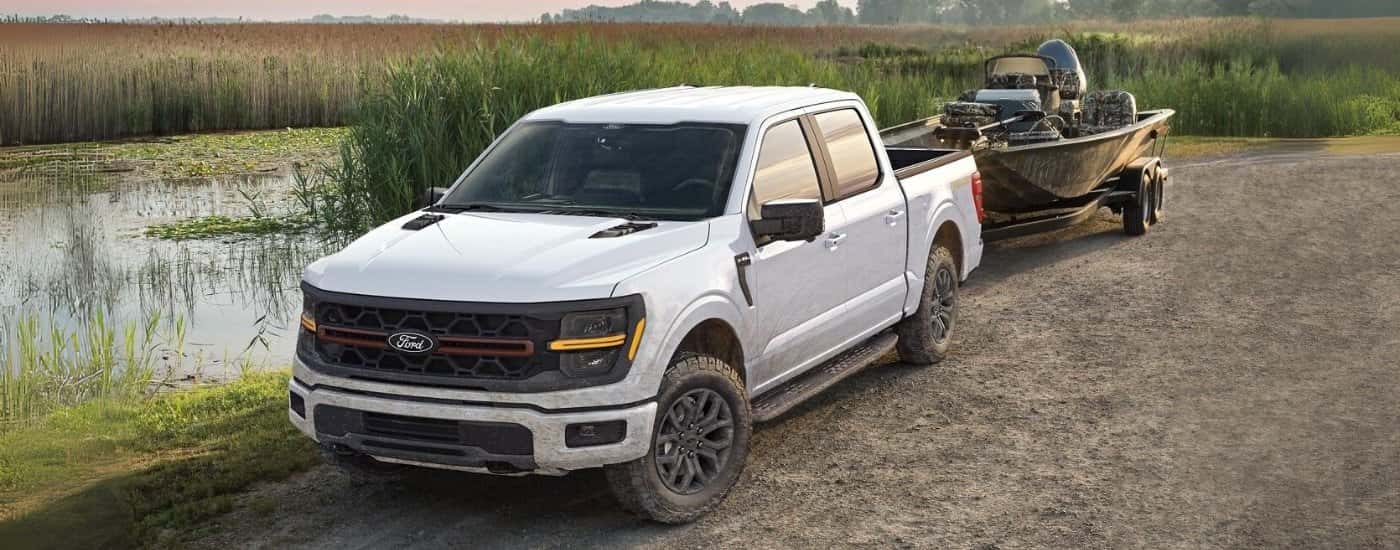 White 2026 Ford F-150 Tremor towing a boat
