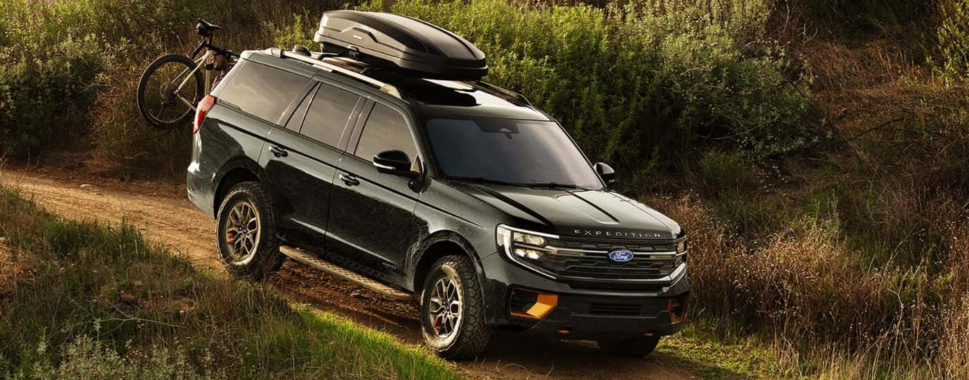 A black 2027 Ford Expedition Tremor shown driving off-road.