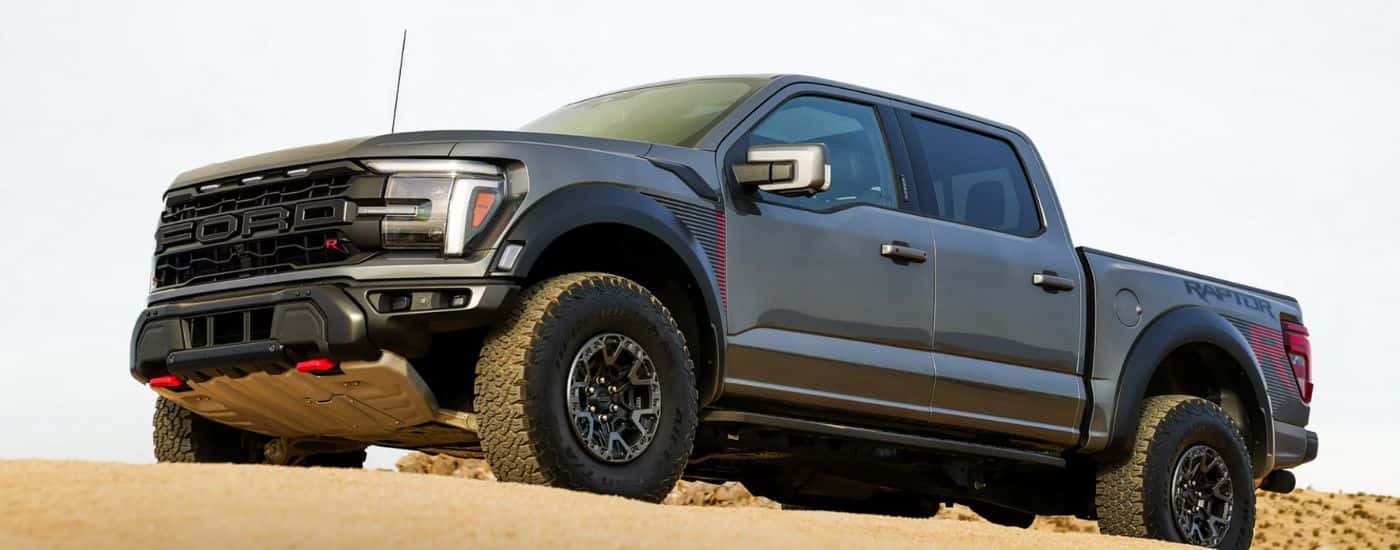A gray 2026 Ford F-150 Raptor R model is parked in the desert.