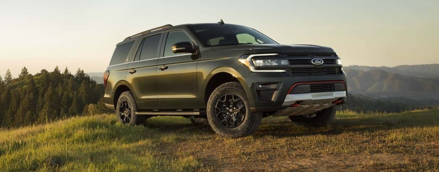 Green 2026 Ford Expedition parked off-road on a hill.