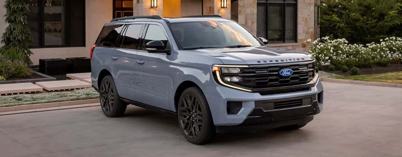 A blue 2027 Ford Expedition parked in a driveway.