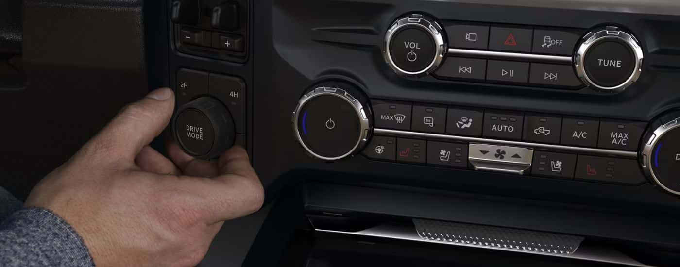 A person adjusting the Drive Mode knob on a 2026 Ford F-250.