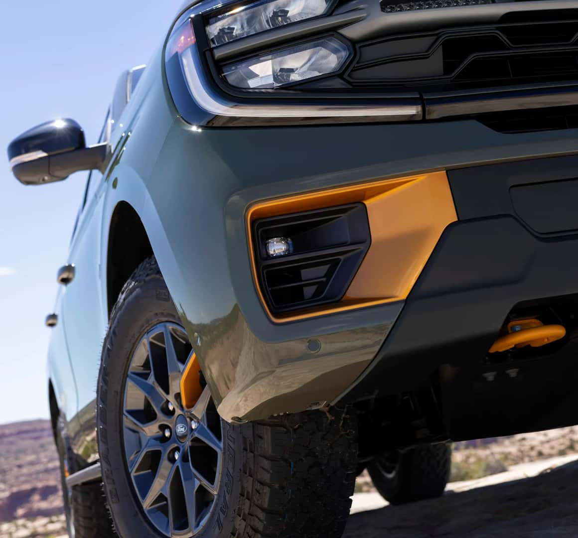 a corner angle view of the LED lights and front bumper of the Ford Expedition