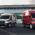 three e-transit vehicle trims parked in front of a warehouse
