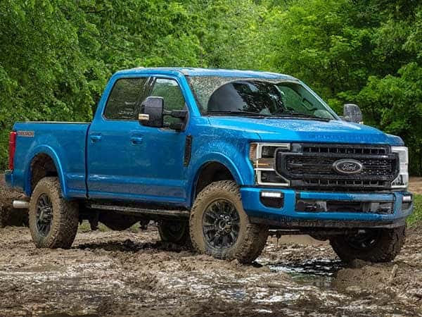 Ford Red Bronco on top of some rocks
