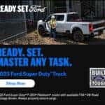 2025 Ford Super Duty® F-250 Platinum® at a construction site with worker – Built Ford Tough.