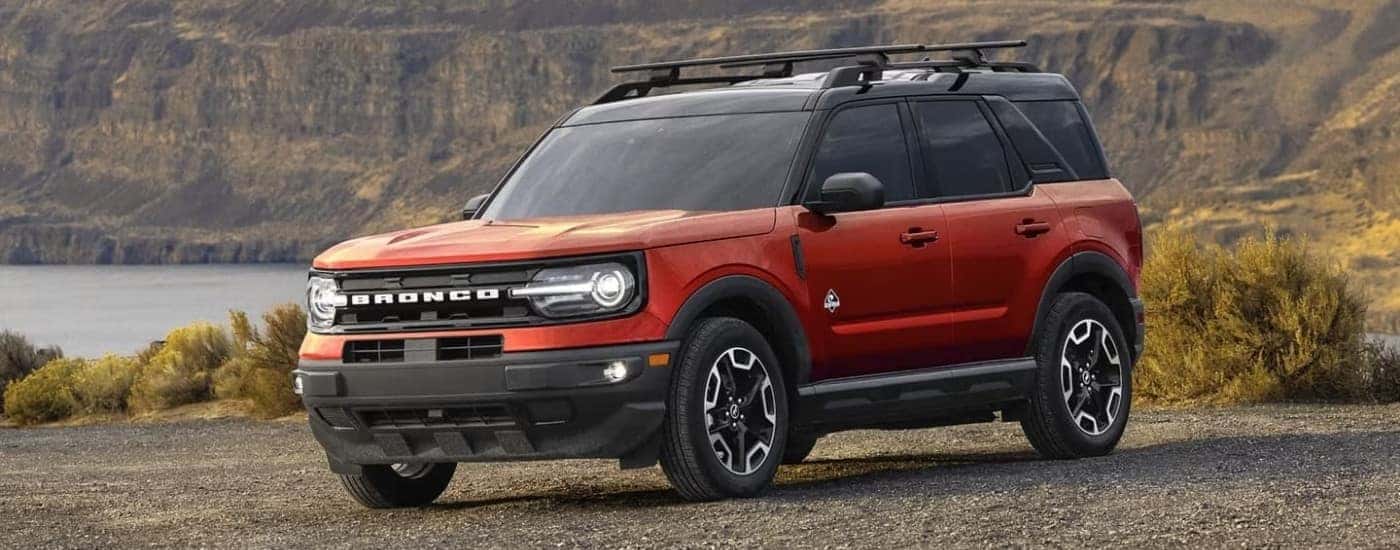 A red 2024 Ford Bronco Sport OuterBanks is shown parked on a coastal lot.