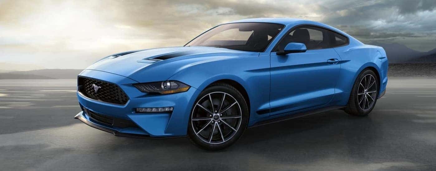 A blue 2022 Ford Mustang parked on a cloudy day.