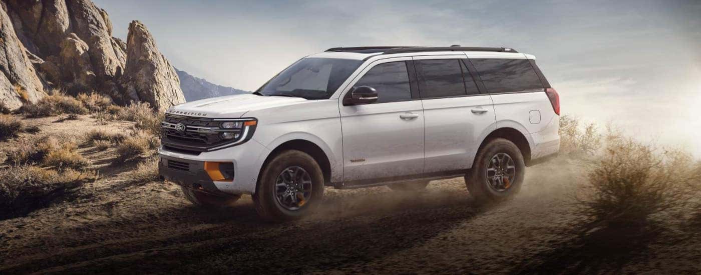 A white 2025 Ford Expedition Tremor is shown off-roading.