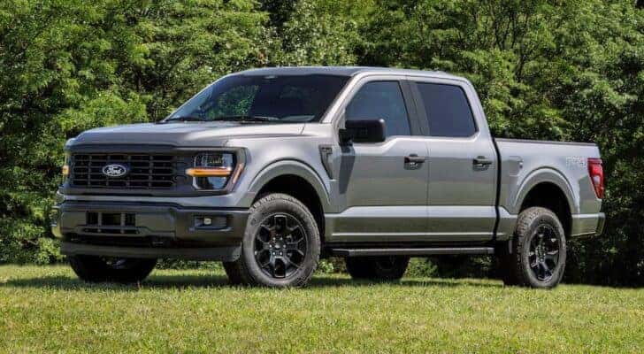 A grey 2024 Ford F-150 for sale is shown from the side.