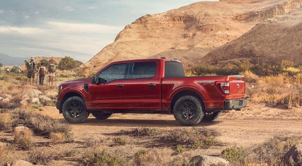 A red 2023 Ford F-150 Rattler parked off-road.