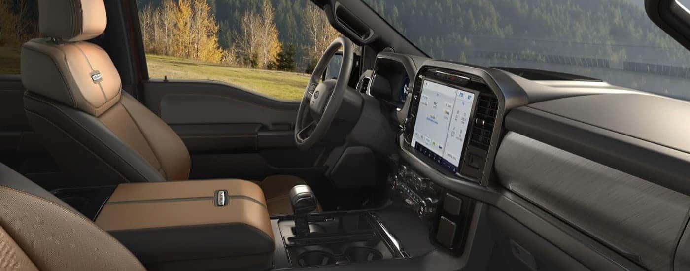 The gray and tan interior and dash are shown in a 2023 Ford F-150 Platinum.