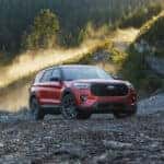 A red 2025 Ford Explorer ST is shown parked off-road.