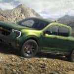 A green 2025 Ford Maverick for sale is off-roading.